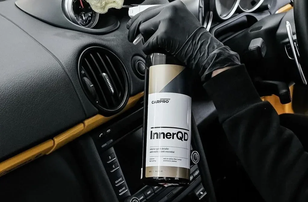 Machine polishing the paint on a dark vehicle
